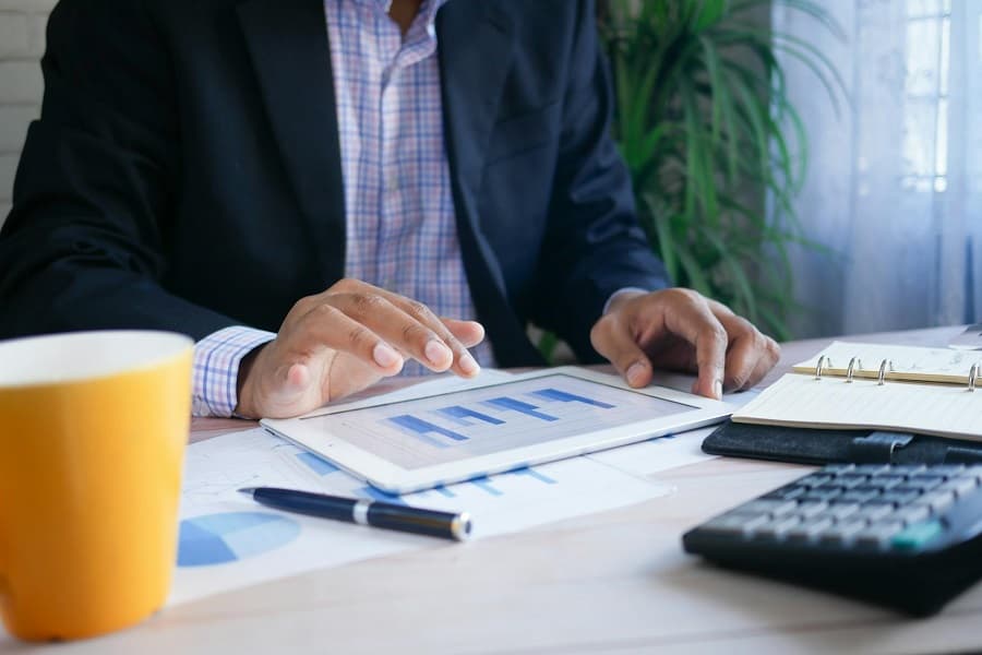 Business-man-using-tablet-and-calculator-on-work-desk